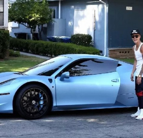 Justin Bieber posa ao lado do Italia 458, carro da Ferrari que ele pintou de azule depois leiloou 